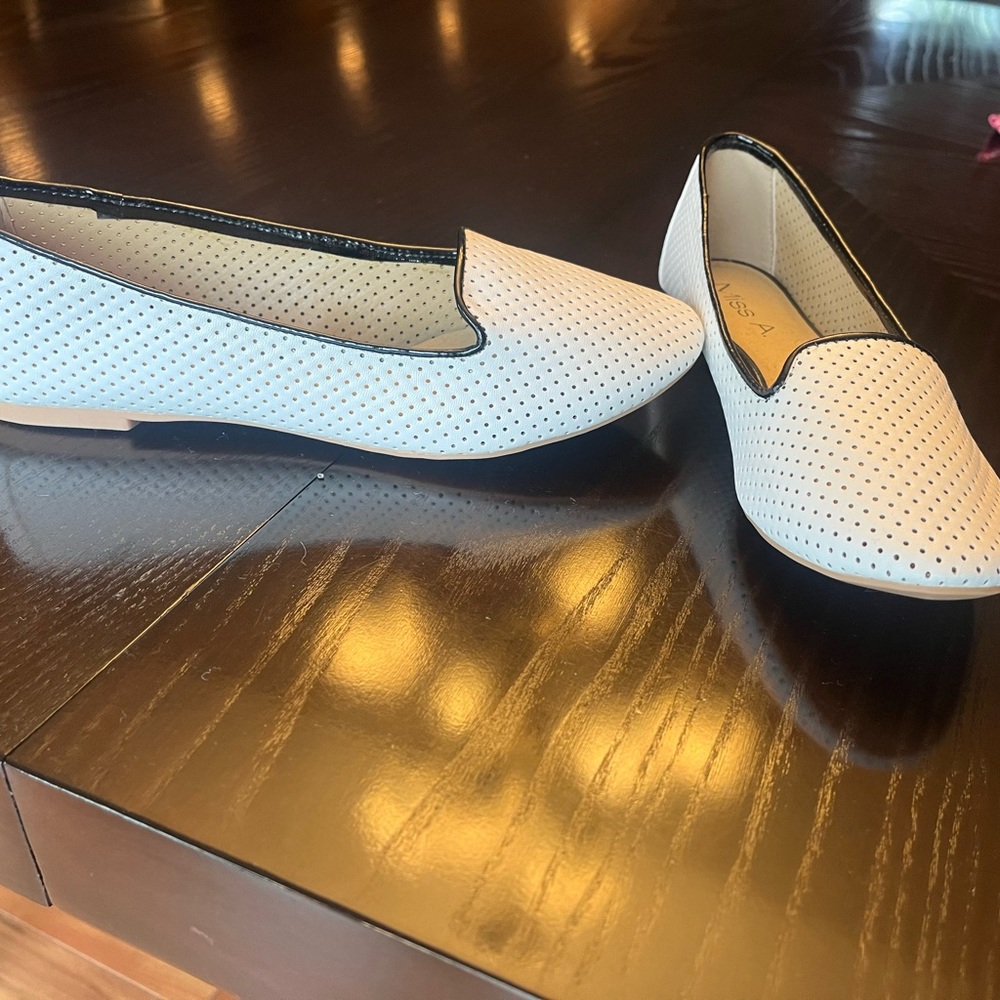 Miss A white leather perforated flats with black trim. Perfect condition.